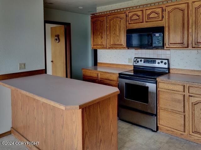 kitchen with kitchen peninsula, stainless steel range with electric cooktop, and backsplash