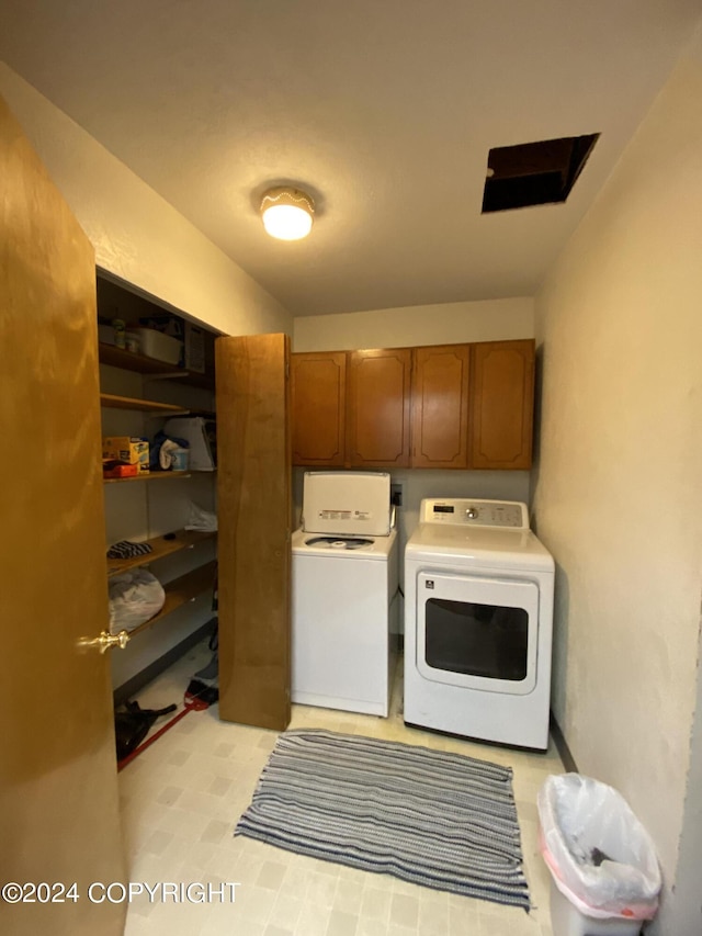 laundry area featuring independent washer and dryer and cabinets