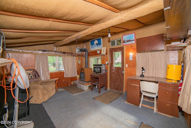 below grade area with a wood stove and wood walls