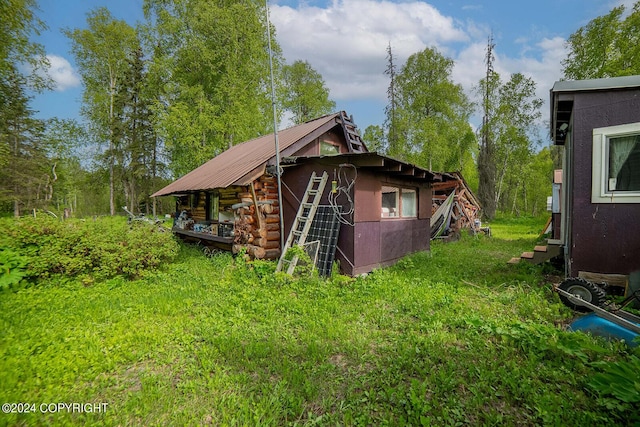 view of home's exterior featuring metal roof and log exterior