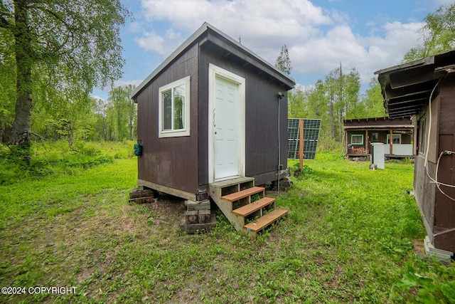 view of outdoor structure featuring entry steps and an outbuilding