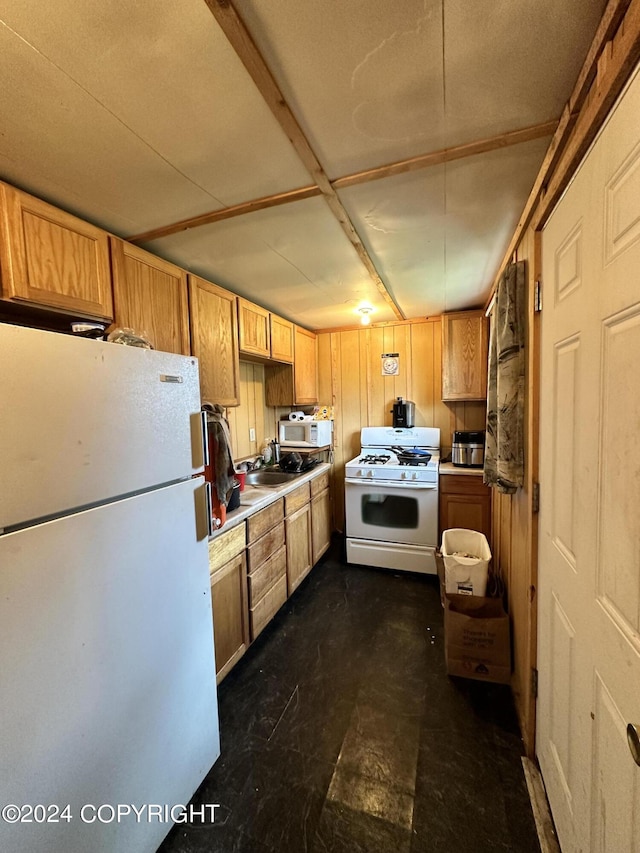 kitchen with light countertops, a sink, and white appliances