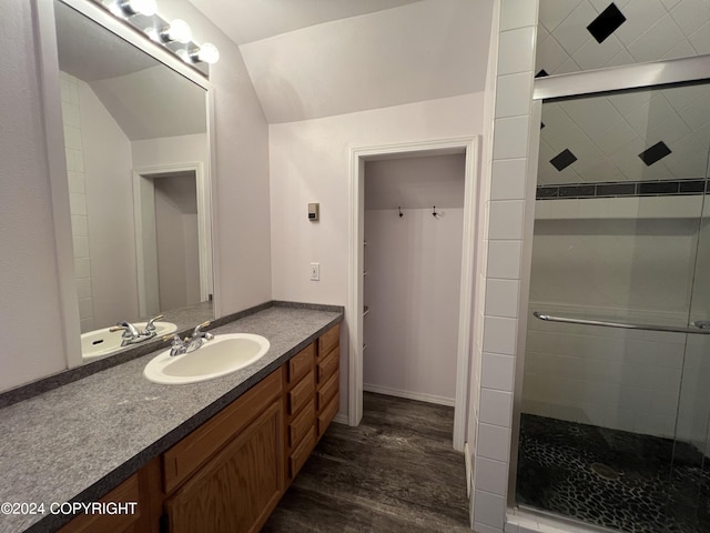 full bath with lofted ceiling, wood finished floors, a shower stall, and vanity