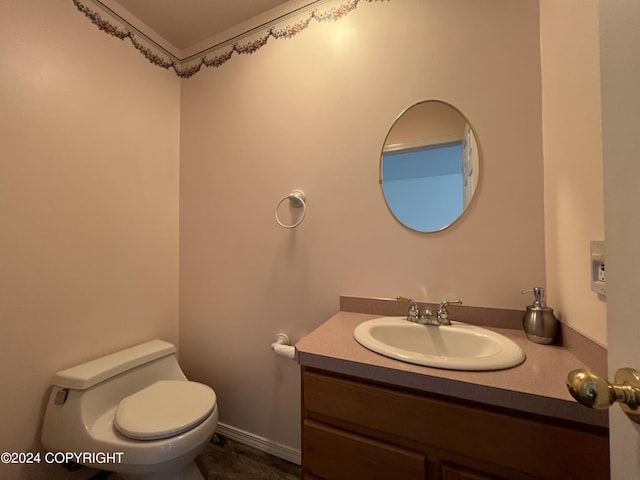 half bathroom with vanity and toilet