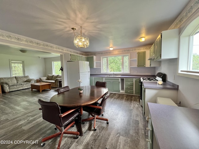 dining space featuring a chandelier, dark wood-style flooring, and plenty of natural light