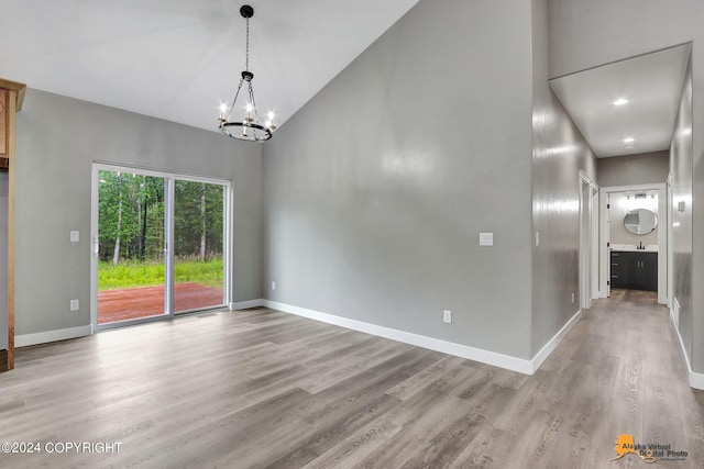 interior space featuring an inviting chandelier and light hardwood / wood-style flooring