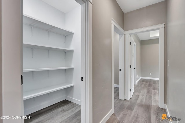 corridor with wood-type flooring