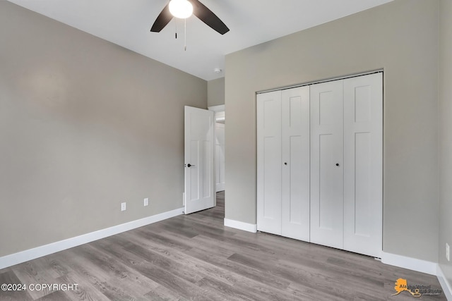 unfurnished bedroom with ceiling fan, a closet, and light hardwood / wood-style flooring