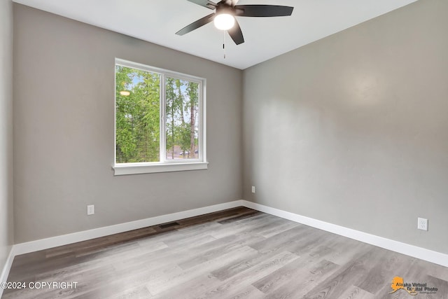 spare room with ceiling fan and light wood-type flooring