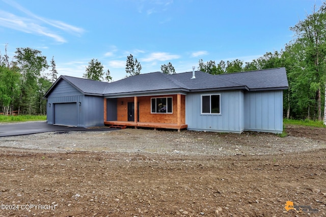 view of front of property with a porch and a garage