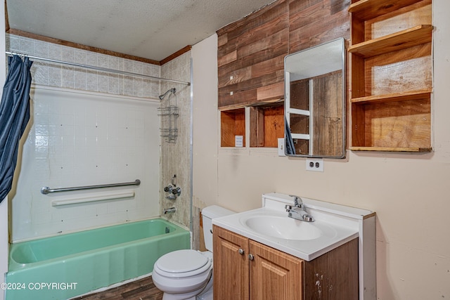 full bathroom featuring vanity, shower / tub combo, a textured ceiling, and toilet