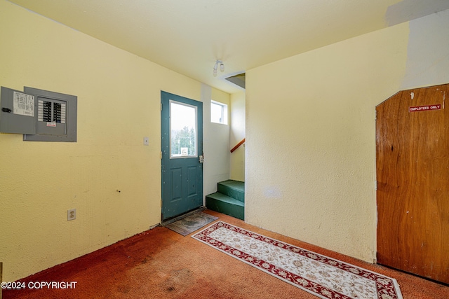 carpeted foyer entrance featuring electric panel