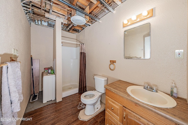 bathroom with hardwood / wood-style flooring, vanity, curtained shower, and toilet