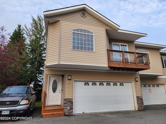 view of front of property with a balcony and a garage