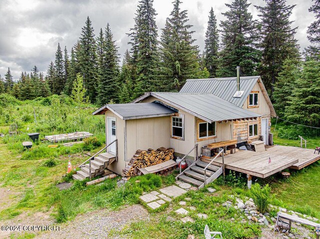 rear view of property with a wooden deck