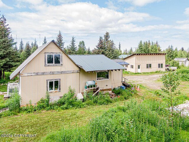 back of property with an outdoor structure