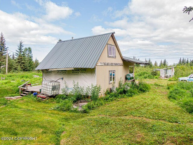 view of side of property with a yard