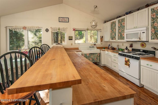 kitchen with lofted ceiling, butcher block countertops, white appliances, white cabinetry, and dark wood-type flooring