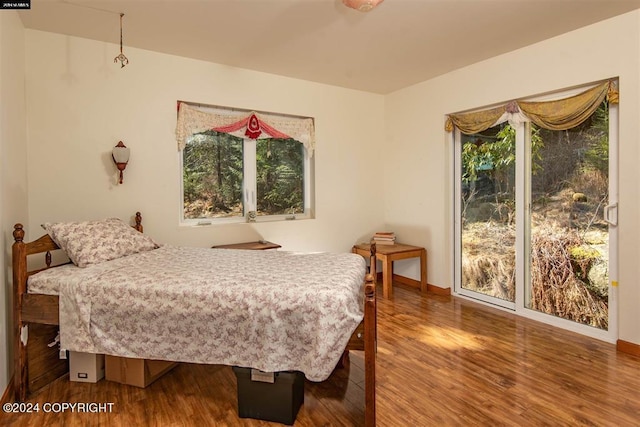 bedroom with hardwood / wood-style floors