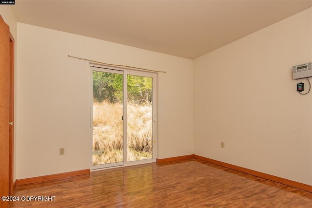 spare room featuring wood-type flooring