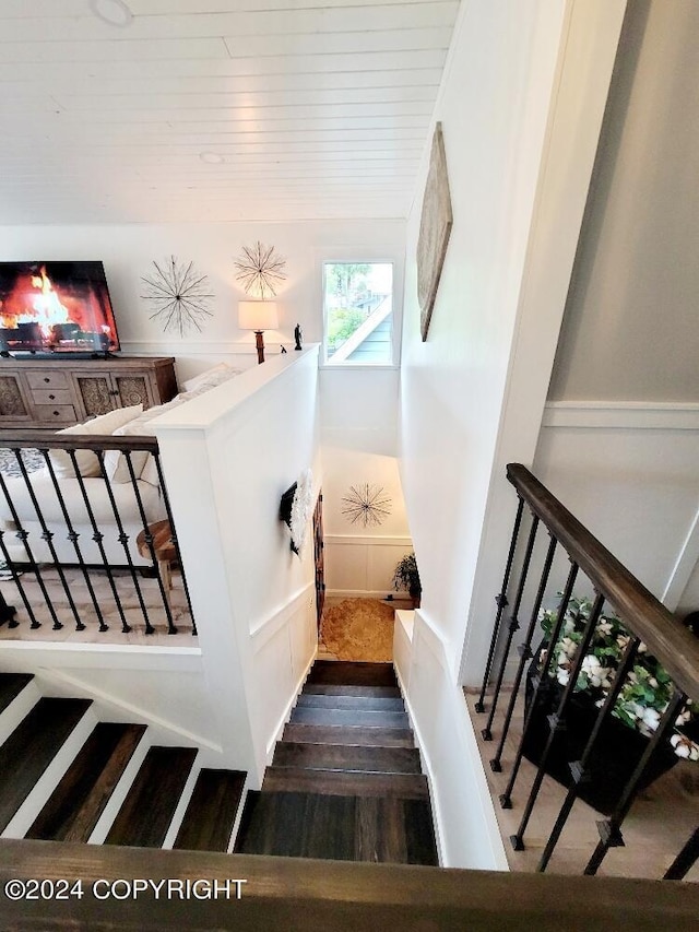 staircase with hardwood / wood-style floors