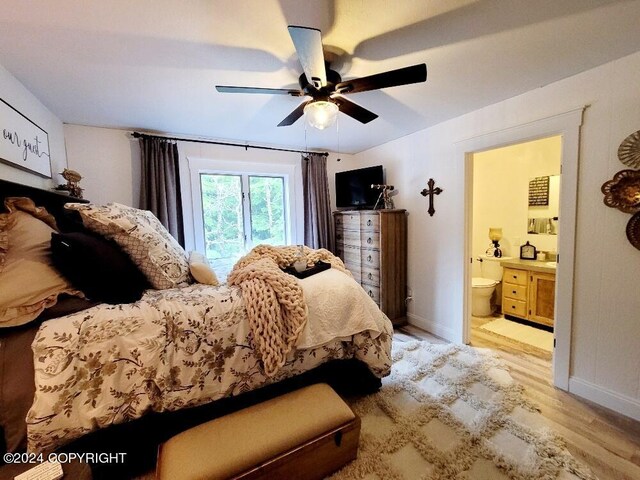 bedroom with ceiling fan, light wood-type flooring, and connected bathroom