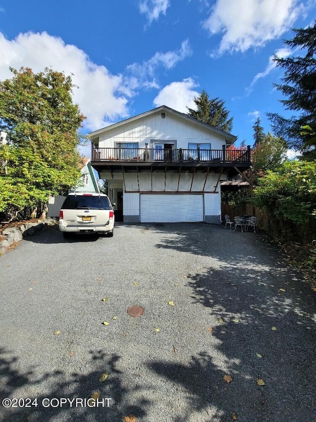 view of home's exterior featuring a balcony and a garage