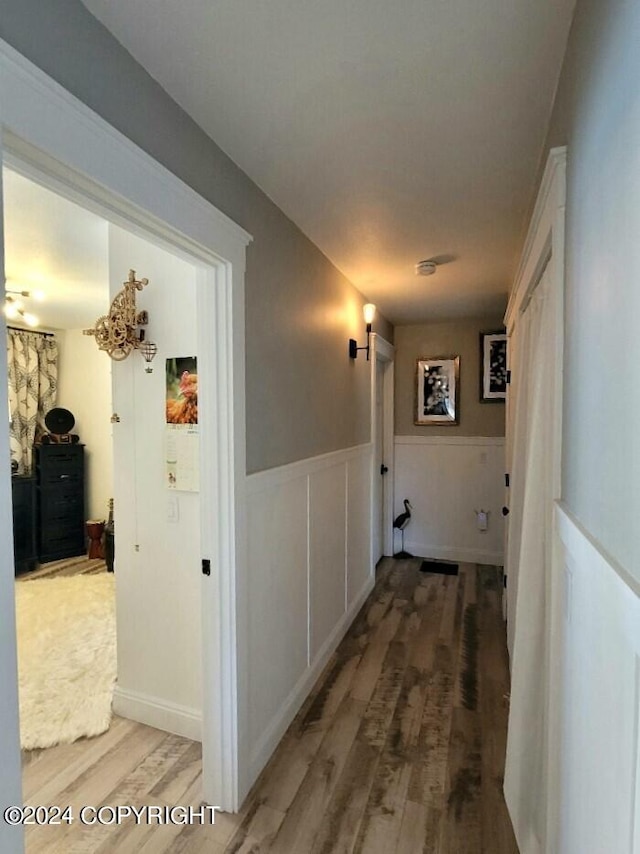 corridor with wood-type flooring