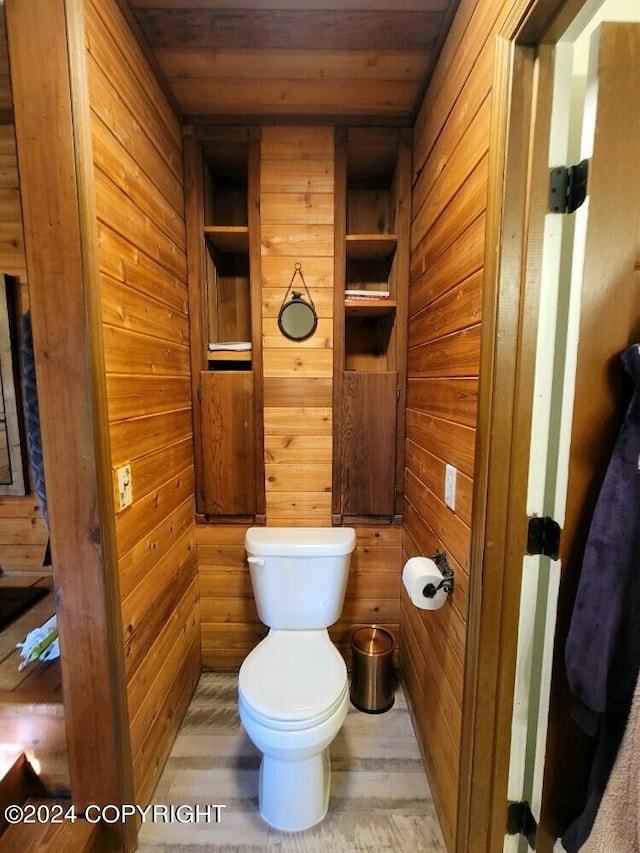 bathroom featuring hardwood / wood-style floors, wood ceiling, wood walls, and toilet