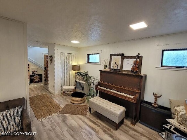 misc room featuring a textured ceiling and hardwood / wood-style floors