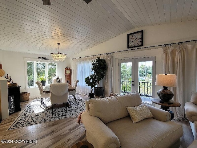 living room featuring lofted ceiling, wood ceiling, french doors, light hardwood / wood-style flooring, and an inviting chandelier