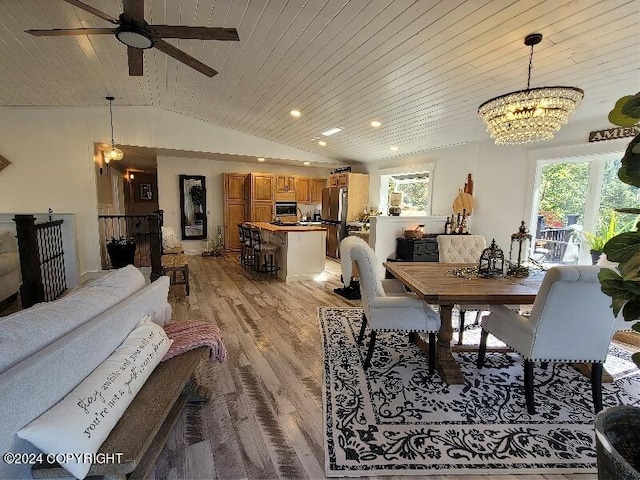 dining area featuring wooden ceiling, ceiling fan with notable chandelier, light hardwood / wood-style floors, and vaulted ceiling