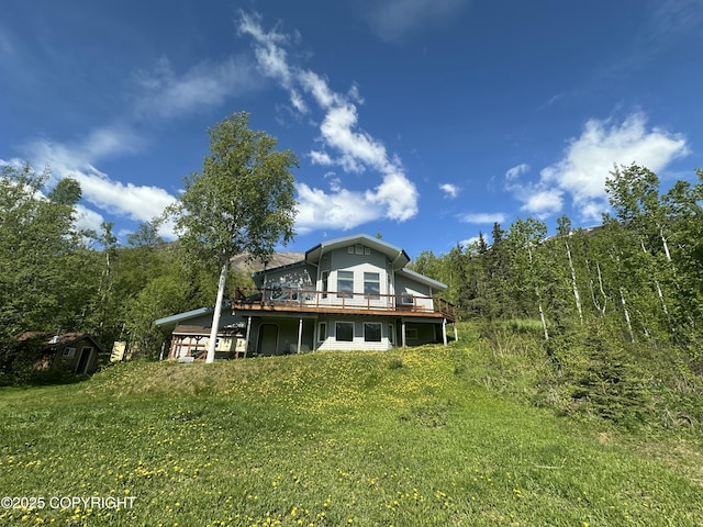 4477 Panther Dr, Eagle River, AK 99577 - back of property featuring a wooden deck and a forest view