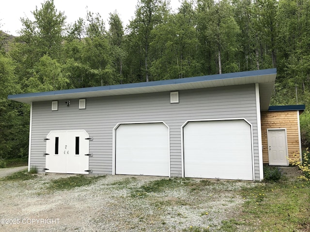 4477 Panther Dr, Eagle River, AK 99577 - detached garage featuring a view of trees