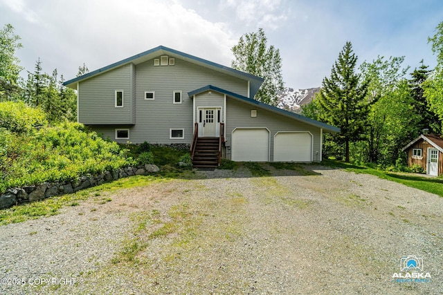 4477 Panther Dr, Eagle River, AK 99577 - view of front of home featuring a garage and driveway
