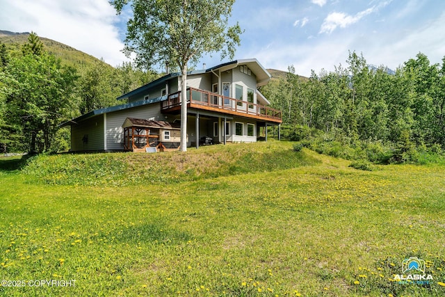 4477 Panther Dr, Eagle River, AK 99577 - back of house featuring a deck with mountain view