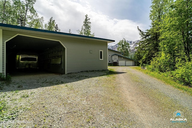 4477 Panther Dr, Eagle River, AK 99577 - view of home's exterior with an outdoor structure and a mountain view