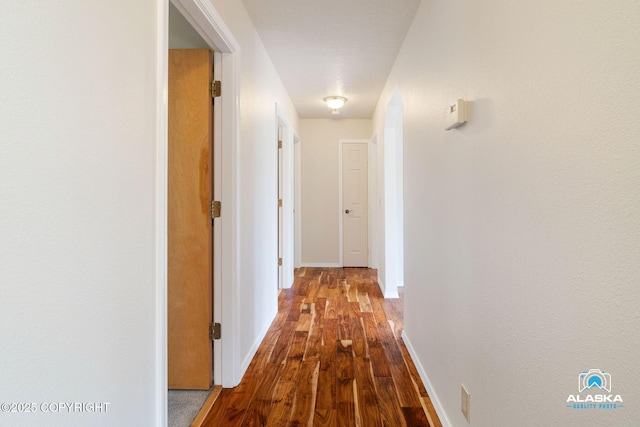 4477 Panther Dr, Eagle River, AK 99577 - hallway featuring dark wood-type flooring and baseboards