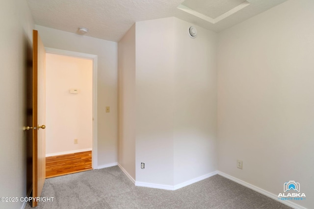 4477 Panther Dr, Eagle River, AK 99577 - unfurnished room featuring carpet, baseboards, a smoke detector, and a textured ceiling