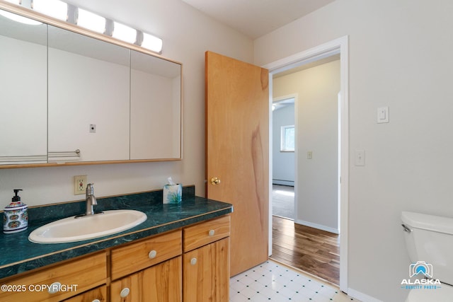 4477 Panther Dr, Eagle River, AK 99577 - bathroom with toilet, a baseboard heating unit, vanity, tile patterned floors, and baseboards