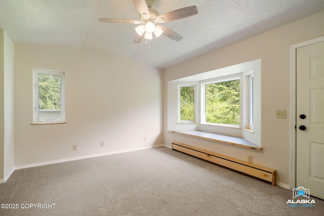 4477 Panther Dr, Eagle River, AK 99577 - spare room featuring baseboard heating, carpet floors, a ceiling fan, baseboards, and a textured ceiling