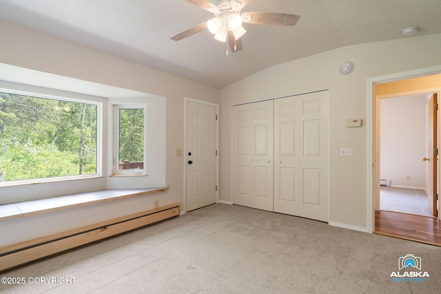 4477 Panther Dr, Eagle River, AK 99577 - unfurnished bedroom featuring a baseboard radiator, carpet, lofted ceiling, baseboards, and a closet