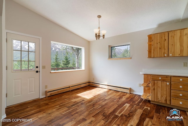 4477 Panther Dr, Eagle River, AK 99577 - unfurnished dining area featuring vaulted ceiling, dark wood-style flooring, and a chandelier