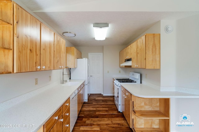 4477 Panther Dr, Eagle River, AK 99577 - kitchen featuring white appliances, under cabinet range hood, dark wood-style flooring, light countertops, and a sink