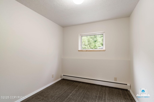 4477 Panther Dr, Eagle River, AK 99577 - spare room with a baseboard heating unit, baseboards, dark colored carpet, and a textured ceiling