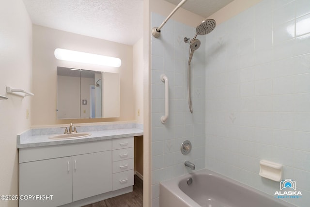 4477 Panther Dr, Eagle River, AK 99577 - full bath with bathing tub / shower combination, vanity, wood finished floors, and a textured ceiling