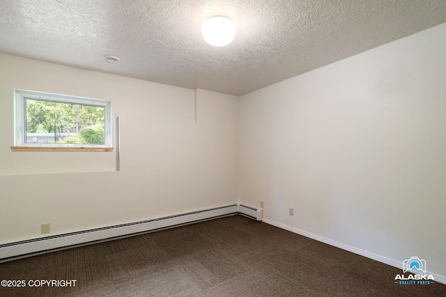 4477 Panther Dr, Eagle River, AK 99577 - spare room featuring a baseboard radiator, a textured ceiling, dark colored carpet, baseboards, and a smoke detector
