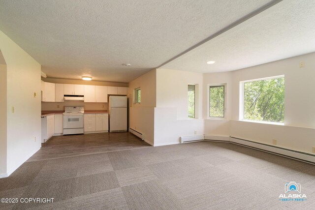 4477 Panther Dr, Eagle River, AK 99577 - unfurnished living room with a baseboard heating unit, carpet flooring, a textured ceiling, baseboards, and recessed lighting