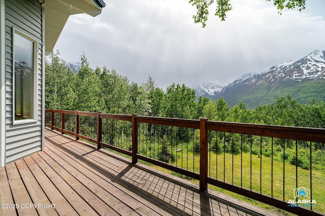 4477 Panther Dr, Eagle River, AK 99577 - wooden terrace featuring a mountain view, a yard, and a wooded view