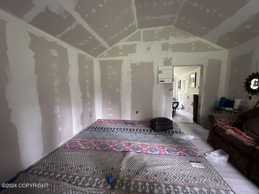 carpeted bedroom featuring vaulted ceiling